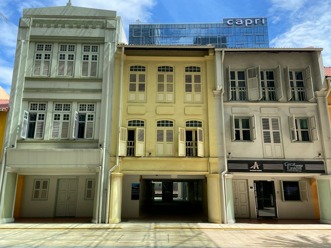 Wide street view of mature landed homes along a quiet Greenwood-style street in Singapore District 11